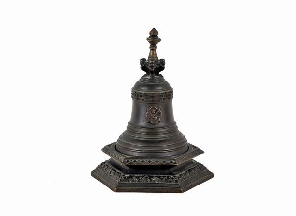 German table bell in bronze with coats of arms and inscriptions in relief resting on a hexagonal base