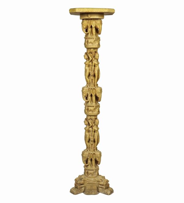 Small faux marble column, with the shaft with small oriental sculptures of divinities, elephants and winged lions