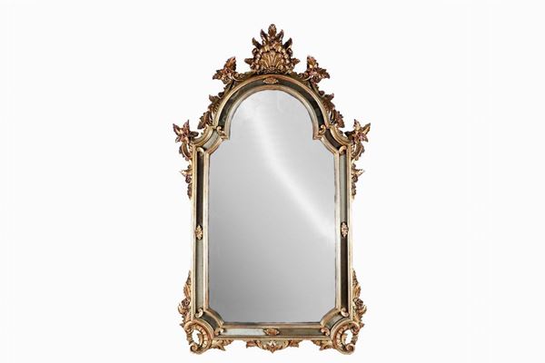 Louis XV line mirror in gilded and silvered wood, with carvings with floral volutes, flowers and shell motifs