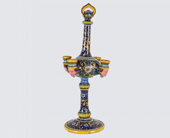 Caltagirone polychrome majolica oil lamp, with floral interweaving decorations on a blue background, four flames with sculptures of male heads