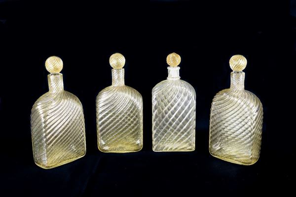 Lot of four Murano blown glass bottles, Toso model, with golden spirals