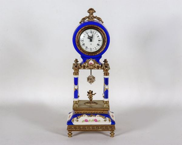 Table clock in the shape of a temple in cobalt blue enamelled porcelain, with gilded metal friezes with Louis XVI motifs