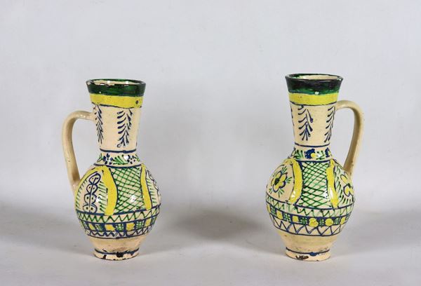 Pair of antique oriental jugs in glazed majolica, with geometric and floral motifs decorations