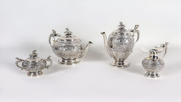 Tea and coffee service in chiseled and embossed silver with scrolls and floral interweaving, with handles in the shape of dragons, (4 pcs) gr. 2120