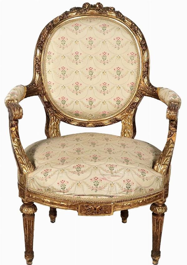Antique French armchair of the Louis XVI line, in gilded wood and carved in relief with motifs of cords, floral intertwining and rosettes