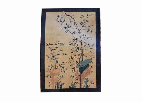 Chinese carpet with blue border and flowered branches, light rapé and various stains, 2.63 x 1.82 m