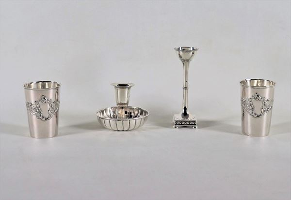 Lot in chiseled and embossed silver of two glasses and two candle holders, (4 pcs) gr. 240