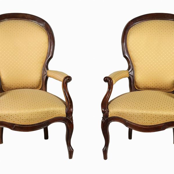 Pair of Louis Philippe armchairs in mahogany, with "trunk" backs and armrests and curved legs