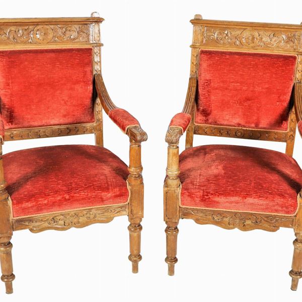 Pair of walnut armchairs from the Renaissance line, with carved backs and armrests, covering in antique pink velvet