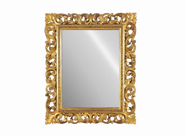 Small mirror in gilded wood, carved and perforated with scrolls of acanthus leaves