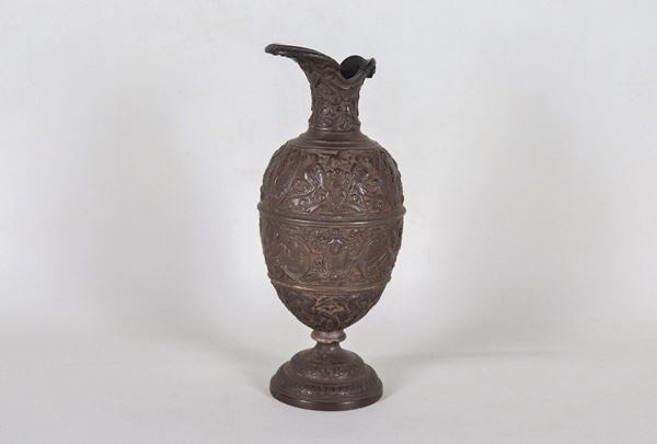 Small antique French amphora, in embossed and chiseled bronze with scrolls and neoclassical motifs