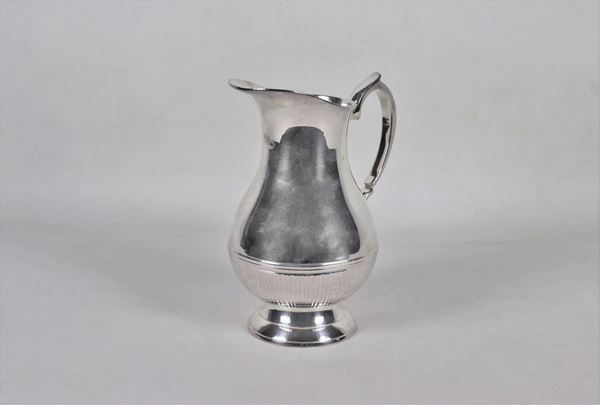 Pitcher in embossed and silvered metal