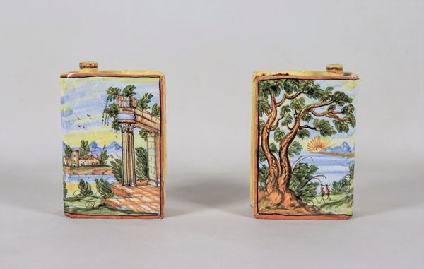 Pair of small book-shaped flasks in enamelled majolica from Pesaro, with polychrome decorations painted with landscape motifs
