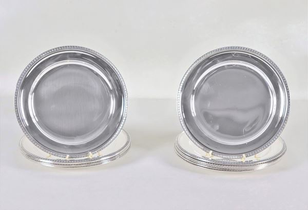 Twelve round silver saucers with chiseled edges with Empire motifs, gr. 2510