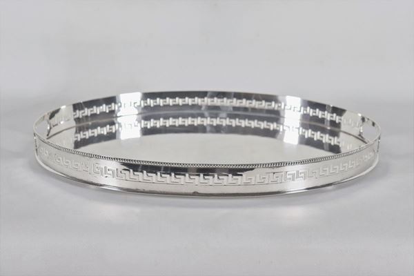 Oval tray in embossed and chiselled silver metal with border with Greek motifs