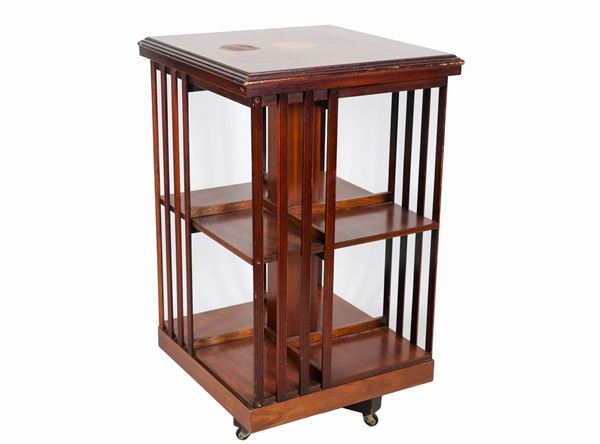English revolving bookcase in mahogany, with inlaid top in satin wood with threads and central rosette