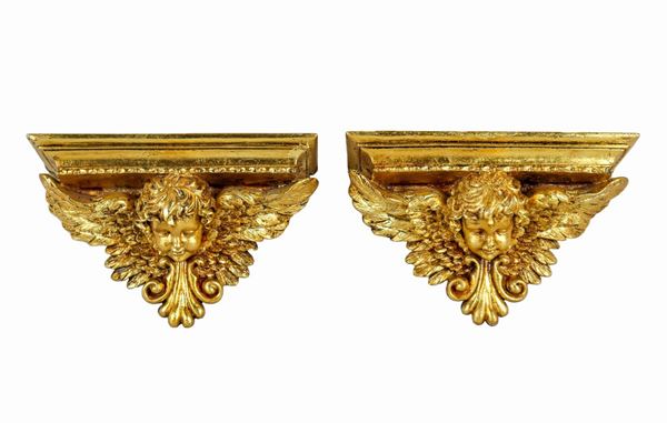 Pair of small wall shelves in gilded wood, with the heads of little angels