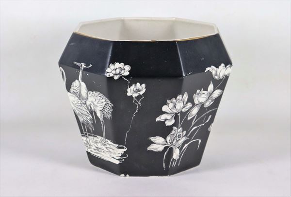 Octagonal vase in glazed earthenware with decorations of flowers and exotic birds in white on a black background