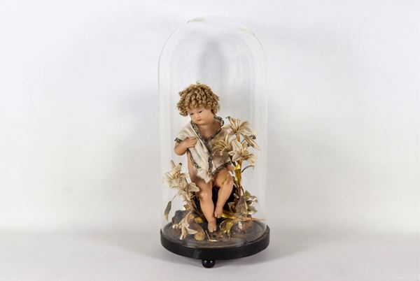 Neapolitan "Bambinello" wax sculpture with lily decorations, blown glass bell and round wooden base
