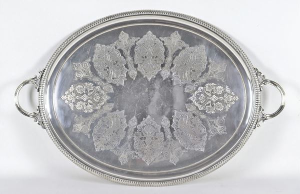 Large oval tray in sheffield, with embossed and chiseled edge and engraved bottom with intertwined scrolls, two handles