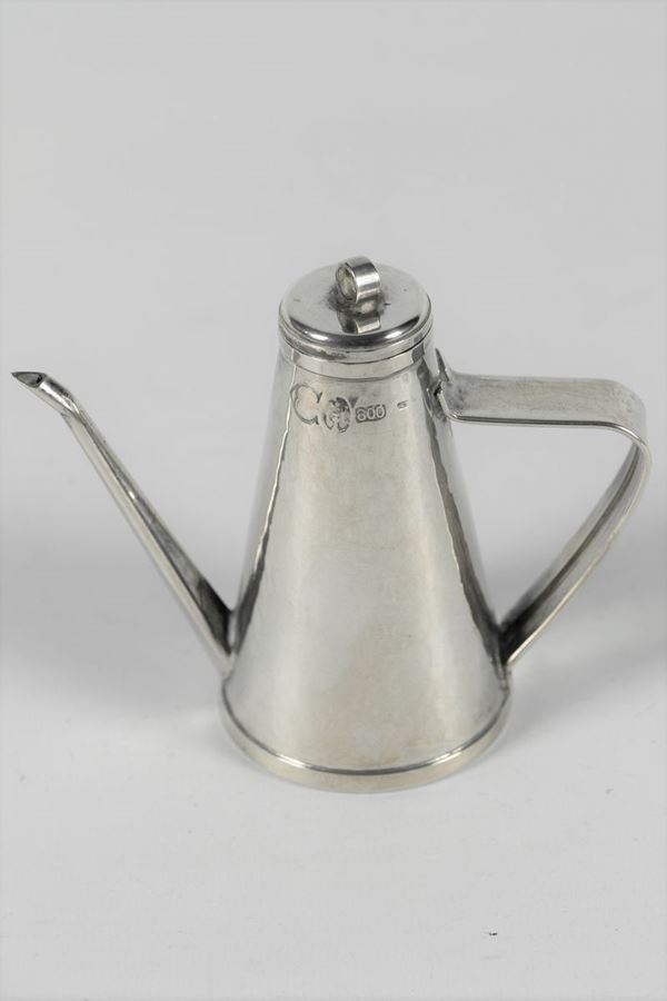 Model of a cruet in hammered silver