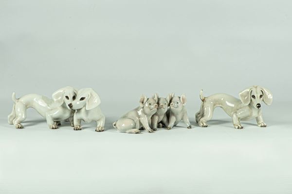 Three small groups in glazed ceramic signed G: Cacciapuoti &quot;Dogs, dachshund and pigs&quot;
