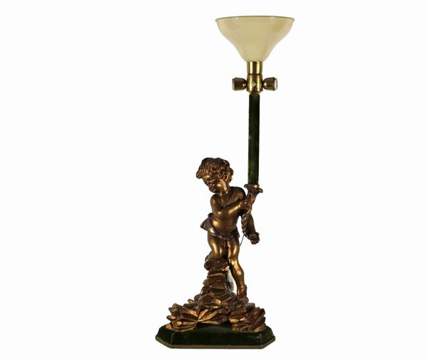 Sculpture "Putto with cornucopia" in gilded and carved wood, base covered in green velvet