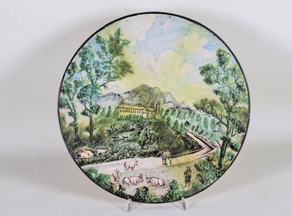 Round majolica with colorful decorations with motifs of "Landscape with shepherds and herds", various restorations