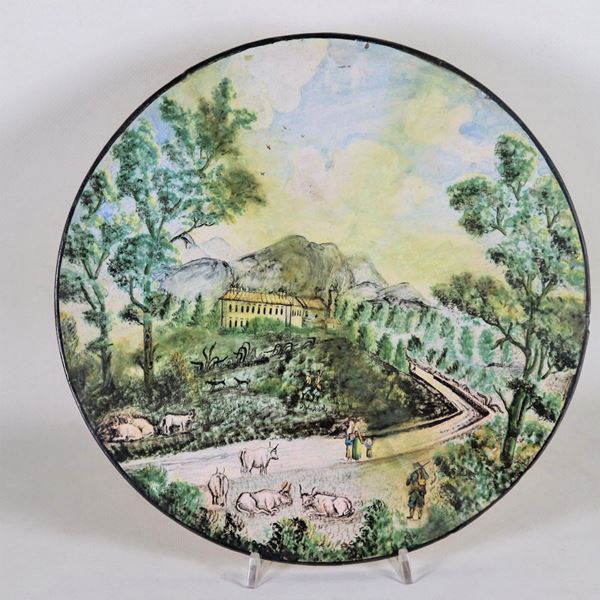 Tondo in maiolica con decorazioni variopinte a motivo di "Paesaggio con pastori e armenti", vari restauri