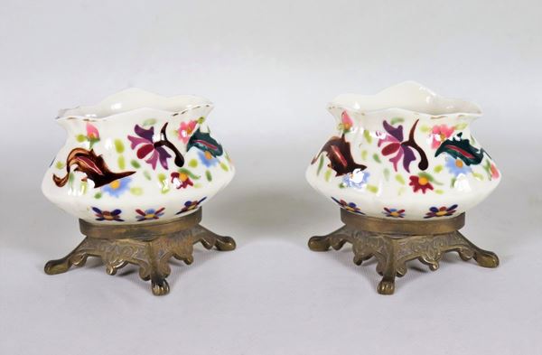 Pair of white porcelain jars, with embossed enamel decorations with floral motifs and bronze bases
