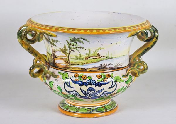Centerpiece in glazed majolica, with colorful decorations with "Landscapes and marine" motifs, handles in the shape of snakes. Marcato F.lli Fuina-Castelli
