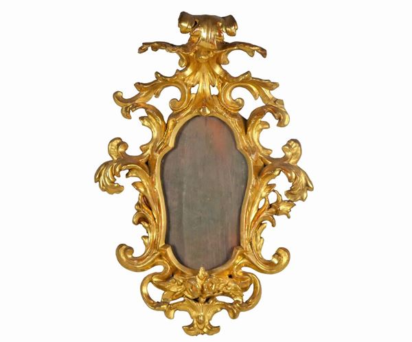 Small mirror in gilded wood and carved with Louis XV motifs of scrolls of acanthus leaves and curls, mercury mirror