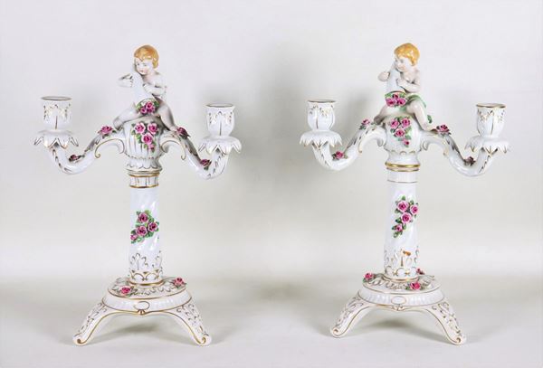 Pair of Capodimonte polychrome porcelain candelabra, with sculptures of "Putti and cornucopias", 3 flames each.