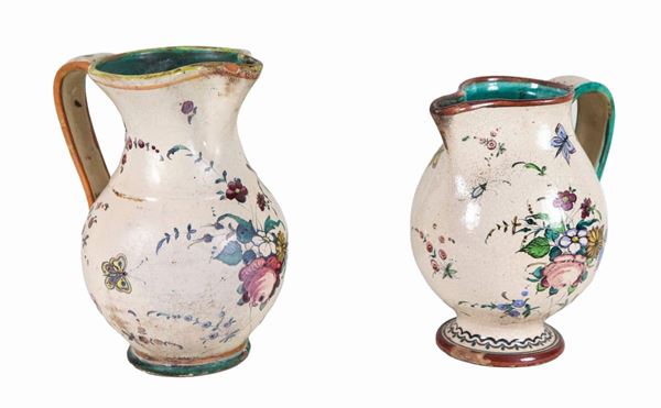 Lot of two Italian glazed majolica jugs with polychrome decorations of flowers and butterflies