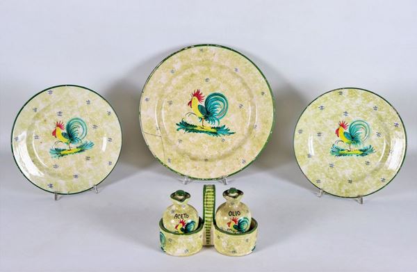Lot in glazed ceramic and decorated with figures of "Roosters", an oil jug, a large round plate and two small ones (4 pcs)