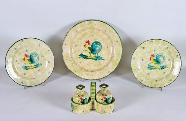Lot in glazed ceramic and decorated with figures of "Roosters", an oil jug, a large round plate and two small ones (4 pcs)