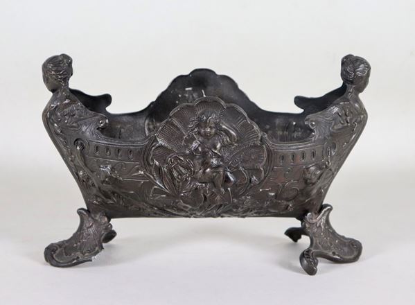 Centerpiece in burnished and patinated metal, with embossed decorations with cherubs, shells and caryatids motifs