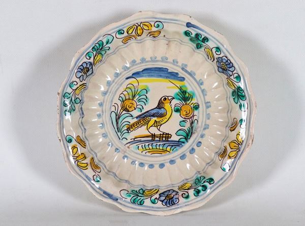 Crespina in glazed majolica San Quirico d'Orcia, with colorful decorations with floral motifs and bird in the center