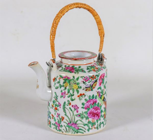 Canton porcelain teapot, with embossed enamel decorations of flowers, parrots and butterflies, handle covered in bamboo