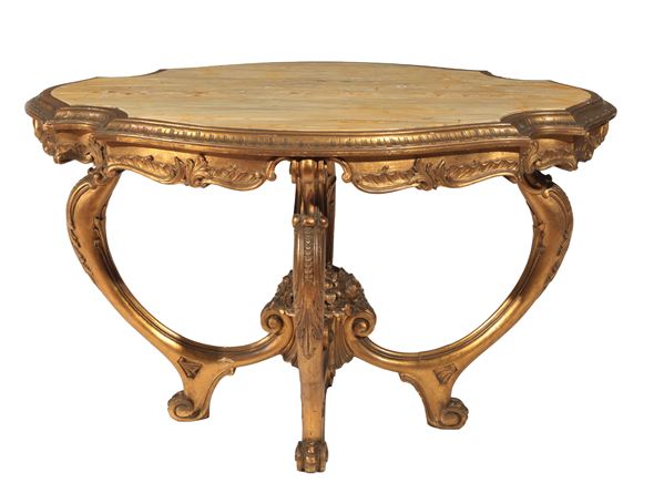 Oval center table in gilded and carved wood, with four curved legs joined by a shaped cross surmounted by a basket of flowers, yellow marble top