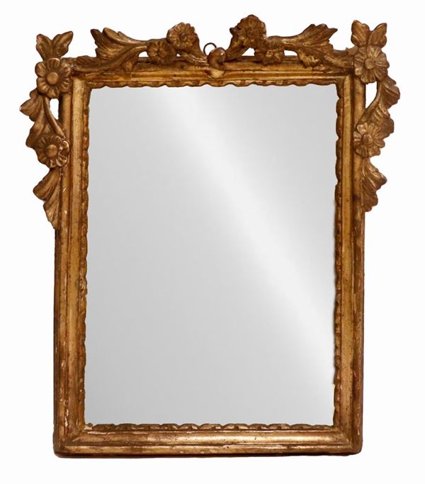 Ancient small Roman mirror in gilded wood and carved with floral scroll motifs, mercury mirror