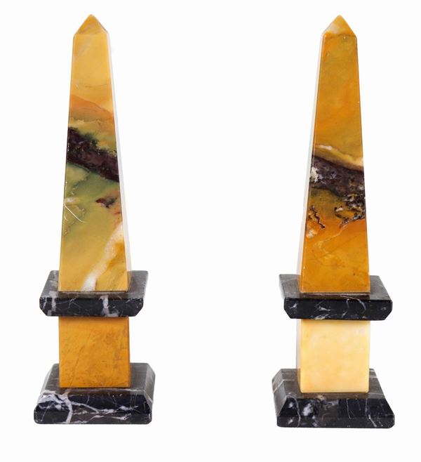 Pair of small obelisks in veined yellow and black marble