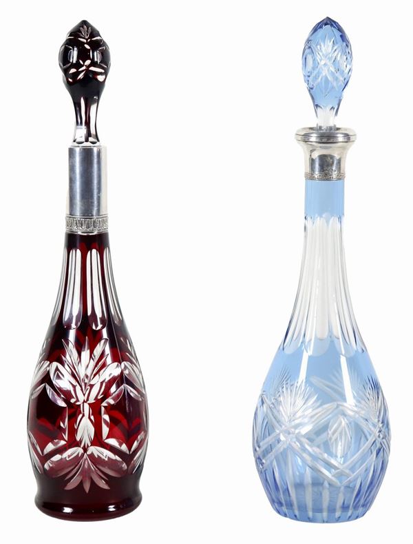 Lot of two Bohemian crystal diamond-tipped bottles with silver-coated necks, one light blue and one ox blood