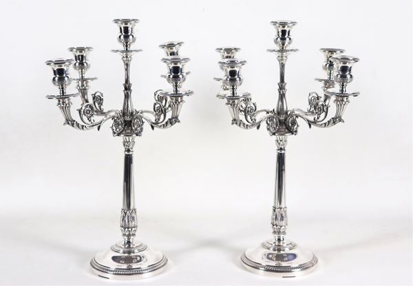 Pair of candlesticks in chiselled and embossed silver with Empire motifs, 5 flames each, gr. 2250