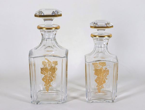 Lot of two square half crystal bottles with golden decorations of bunches of grapes