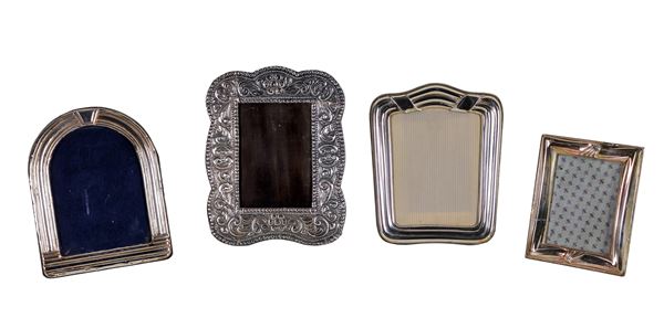 Lot of four photo frames in chiselled and embossed silver