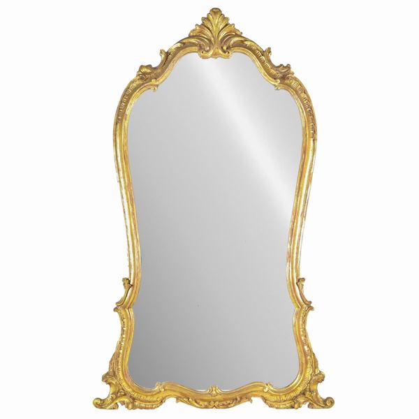 Specchiera francese di linea Luigi XV a forma centinata, in legno dorato e intagliato a motivi di volute e ricci