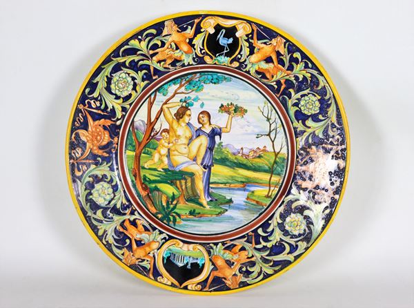 Parade dish in glazed and glazed majolica, marked Palatino Ars - Borzelli Roma, entirely multicolored in relief with a mythological scene in the center