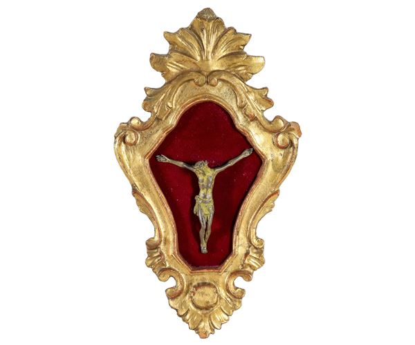 Antico piccolo crocifisso in bronzo in cornice in legno dorato e intagliato, fondo in velluto rosso