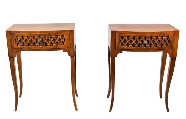 Pair of semi-oval nightstands in walnut, with central drawer carved with rhombus motifs, four legs each